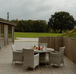 An outdoor seating area with a table and chairs at Wellington in Wigton