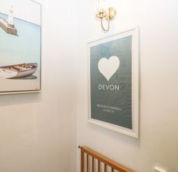 A hallway with artwork and framed print at 58A South Ford Road in Dartmouth