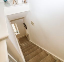 A staircase leading down with a window at 58A South Ford Road Dartmouth