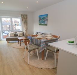 A dining room with a table and chairs at Brewery View in Weymouth