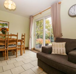 A dining room with a table and chairs at Dovecote Cottage in Corse near Gloucester