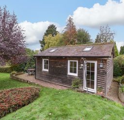 A cabin in a garden at The Log Cabin in Corse near Gloucester
