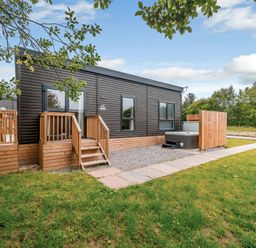 An outdoor area with wooden steps and a hot tub at Somersby Spa in Louth