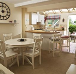 A dining room with a table and chairs at St Leonards in Salcombe