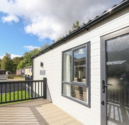 A deck with a door and window at Altair Lodge in 