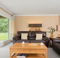 A living room with a sofa and coffee table at The Allensford in Slaley