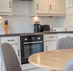 A kitchen with an oven and kettle at Kernow Nook Spa in Perranporth