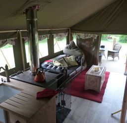 A tent with a sofa and stove in Ceri Newcastle Emlyn