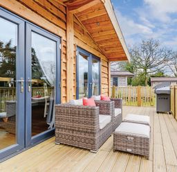 A deck with seating and sliding doors at Typhoon Lodge in Winchester