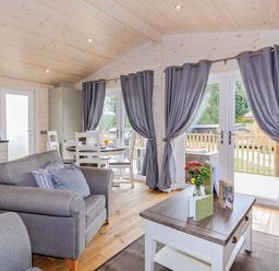 A living room with a sofa and table at Typhoon Lodge in Winchester