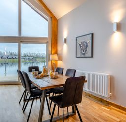A dining room with a table and chairs at Tranquillity 3 Warton near Carnforth