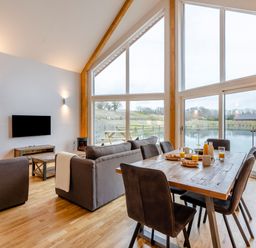 A living room with sofa and dining table at Tranquillity 3 in Warton near Carnforth