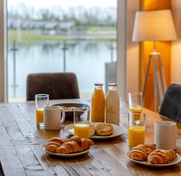 A dining room table with breakfast items at Tranquillity 3 in Warton near Carnforth