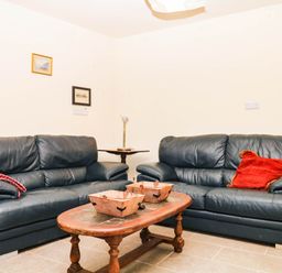 A living room with sofas and a coffee table at The Gables in Teignmouth