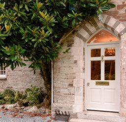 An entrance door with a tree beside it at Ladye Park in Liskeard