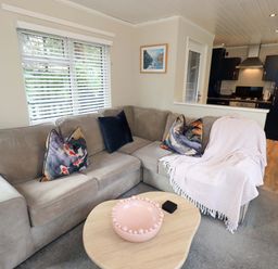 A living room with a sofa and coffee table at Evermore Lodge, 48 Calgarth Park, White Cross Bay, Windermere