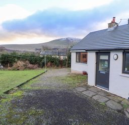 A garden with a house and mountain view at Westerlodge Threlkeld near Keswick