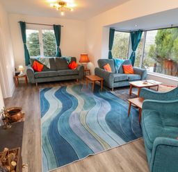 A living room with sofas and a coffee table at Westerlodge Threlkeld near Keswick