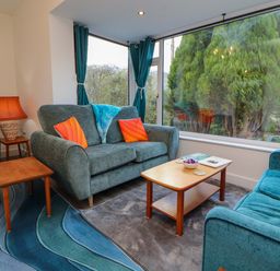 A living room with sofas and a coffee table at Westerlodge Threlkeld near Keswick