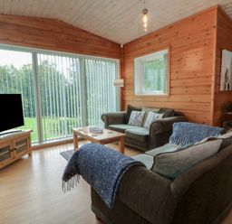 A living room with a sofa and coffee table at Woodlands View in Leek