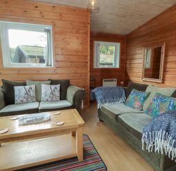 A living room with sofas and a coffee table at Woodlands View in Leek