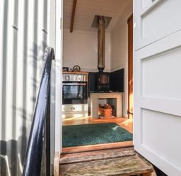 A kitchen with a stove and oven at Hillbre Shepherd Hut in Padstow