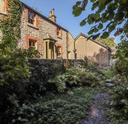 A view of houses and garden area at Rock Cottage in Milnthorpe