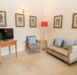 A living room with a television and seating area at Woodcock Studio Andoversford near Cheltenham