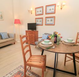A dining room with a table and chairs at Swallow Studio Andoversford near Cheltenham
