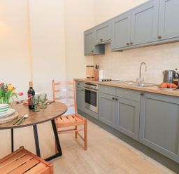 A kitchen with a table set for a meal at Swallow Studio Andoversford near Cheltenham