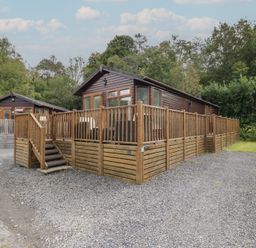 A cabin with a wooden deck and steps at 32 Grasmere in Windermere