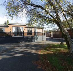 A house with a deck and windows at 7 Lake View, Lake View 7, White Cross Bay near Windermere