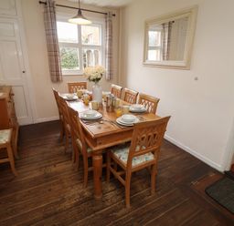 A dining room with a large table set for breakfast at Duke Cottage in Woodbridge