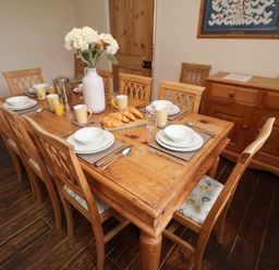 A dining room with a table set for breakfast in Duke Cottage Woodbridge