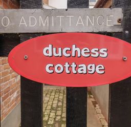 Sign indicating duchess cottage at outdoor entrance