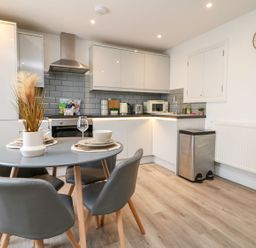 A kitchen with a dining table and chairs at Klysa in Camborne