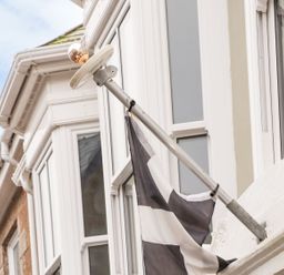 A flag flying on a pole attached to a building at Baker Chambers Camborne