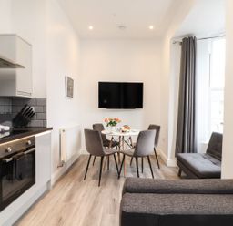 A kitchen with a dining area and a television at Baker Chambers in Camborne