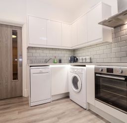 A kitchen with appliances and cabinets at Teylu in Camborne