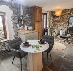 A dining room with a table and chairs at Gwyn Studio in Aberdare