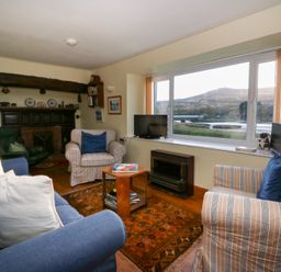 A living room with sofa, coffee table and television at Bryncyn in Newport, Pembrokeshire