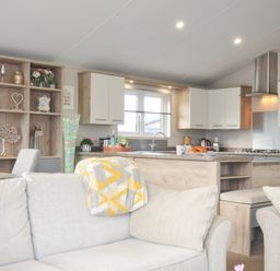 A kitchen with dining table and sofa at 2 Summerleaze Bude