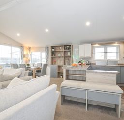 A living room with a kitchen area at 2 Summerleaze in Bude