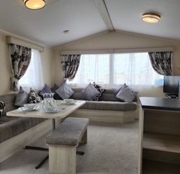 A living room with a sofa and dining area at 123 Elms in 