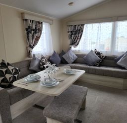 A dining area with a sofa and table set at 123 Elms