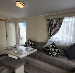 A living room with a sofa and dining table at 123 Elms in 