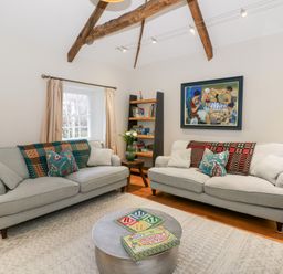 A living room with sofas and a shelf in Secret Garden Cottage Ciliau Aeron near Aberaeron