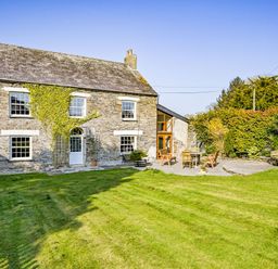 A house with a garden and seating area at The Old Farm House near Pelynt