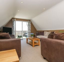 A living room with a sofa and table at Valley Lodge 61 Callington