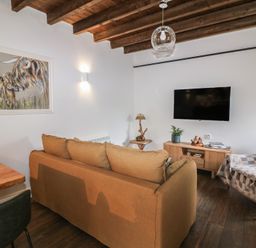 A living room with a sofa, table, lamp, and television at The Loft in Glenmore, County Kilkenny